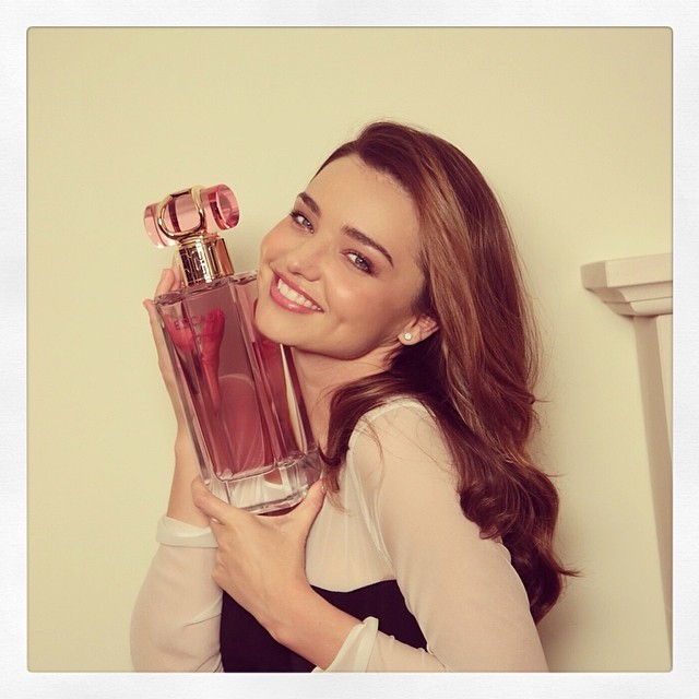 Miranda Kerr smiles with Escada bottle