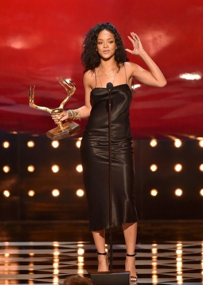 Rihanna covered up from her recent CFDA look in a minimal black dress