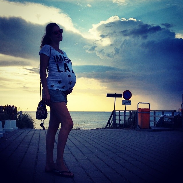 A pregnant Doutzen Kroes at the beach