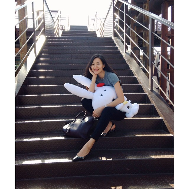 Liu Wen poses on steps with a bunny
