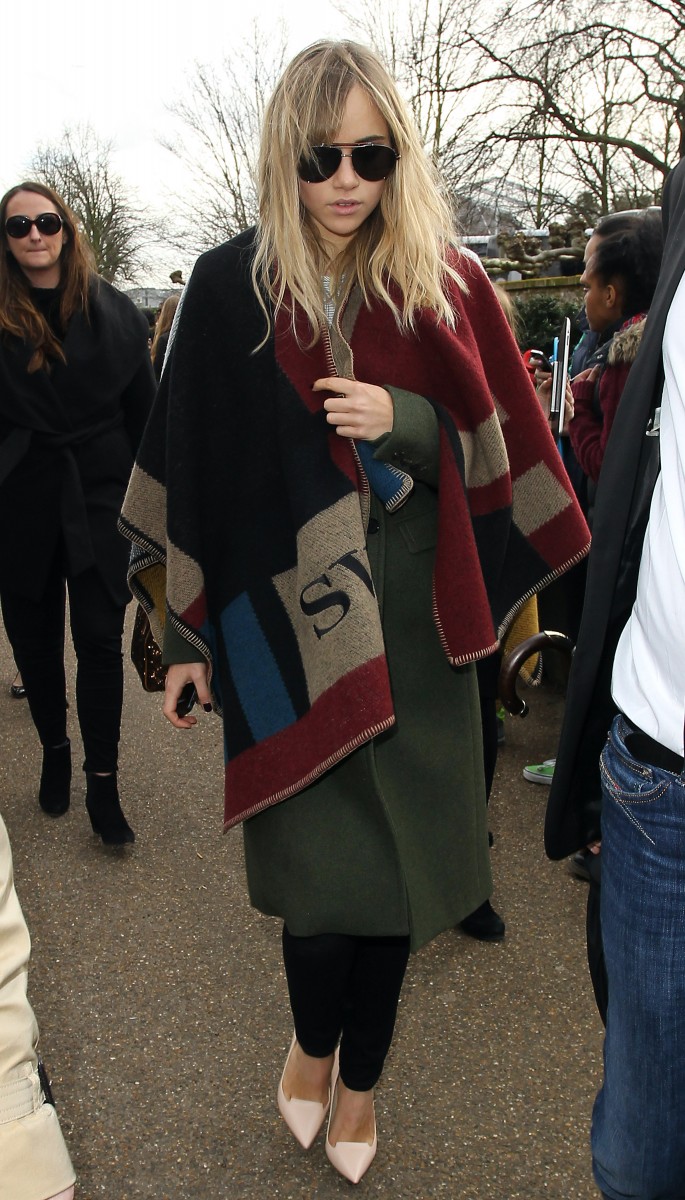 Suki Waterhouse Wears Burberry Monogrammed Poncho in London. Photo: Film Magic