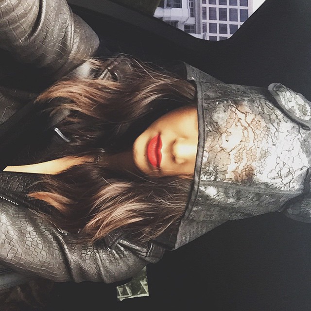 Kendall Jenner shows off red lip color and hooded style