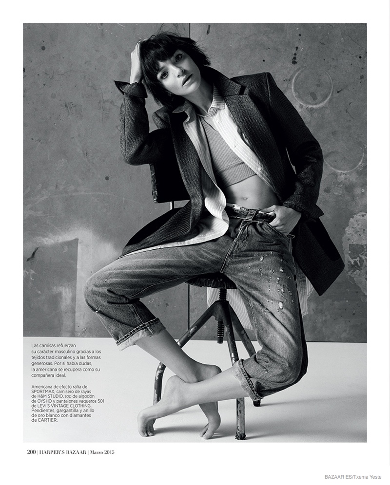 The brunette layers in cropped denim jeans, a coat, top and cropped sweater in the fashion feature.