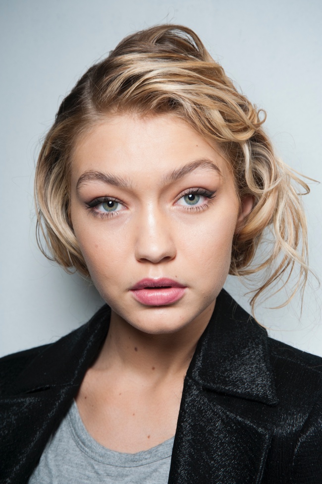 Gigi Hadid with a messy updo channeling 1950s beauty at the Max Mara Fall 2015 show. 