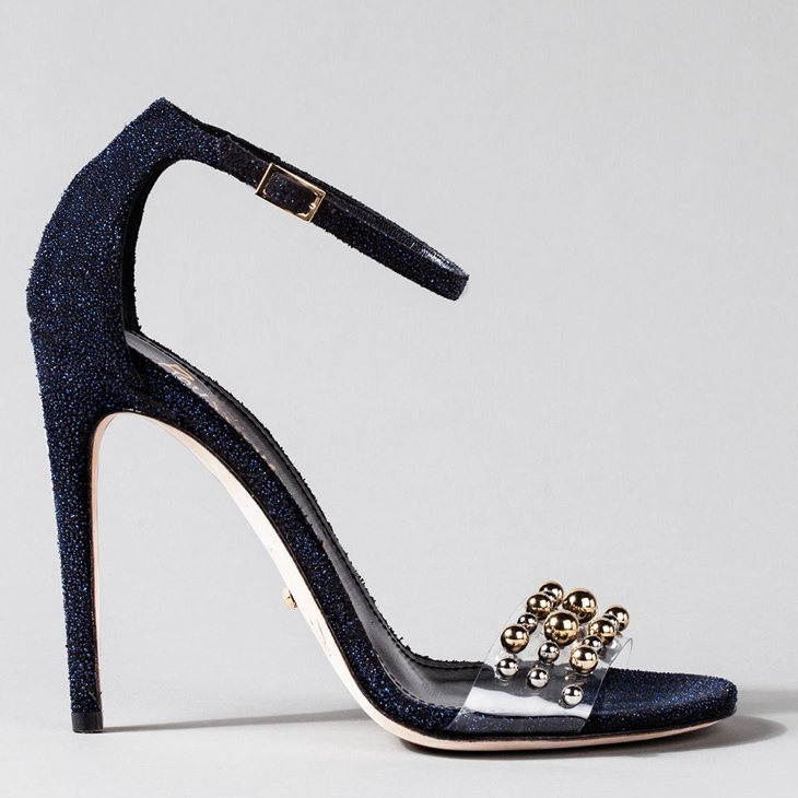 Jerome Rousseau went in a nontraditional direction with a shoe inspired by the stroke of midnight—playing off the color of the sky at night. The clear strap serves as a reminder of crystal slipper with gold and silver embellishments. 