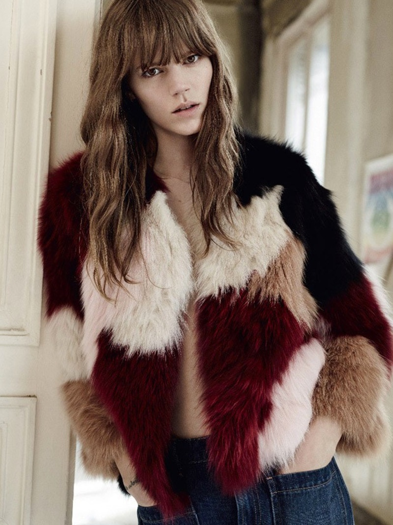 The model poses in a fur multi-colored coat