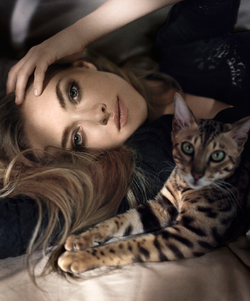 Amanda poses with a cat in the photo shoot