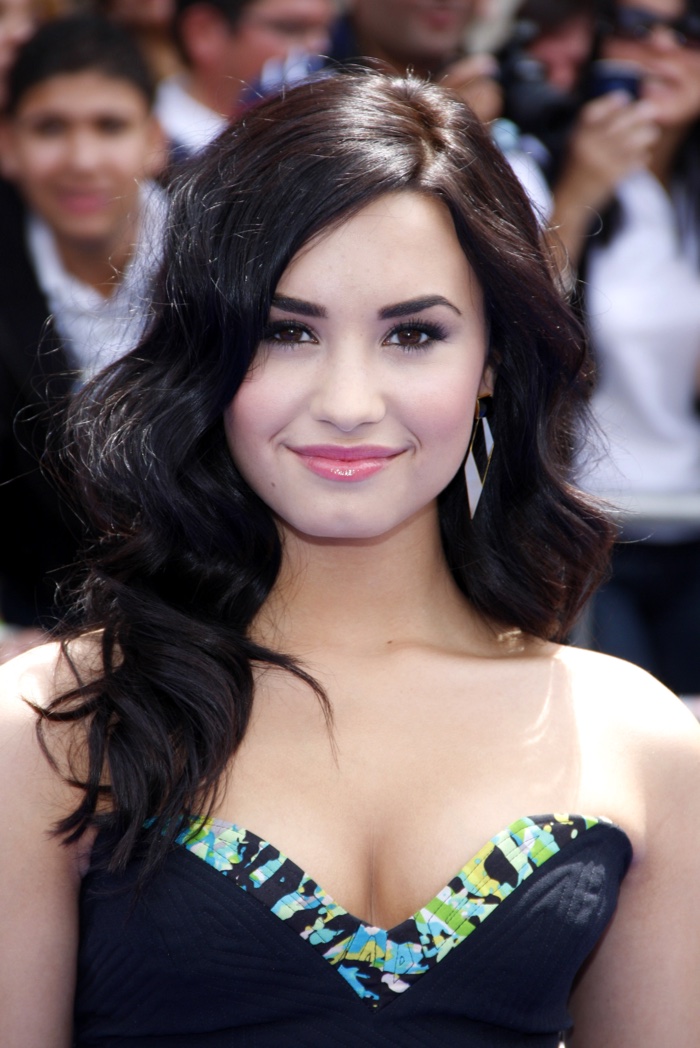 Demi Lovato showed off a long and wavy hairstyle featuring a darker shade of brown at a 2010 movie premiere. Photo: Tinseltown / Shutterstock.com