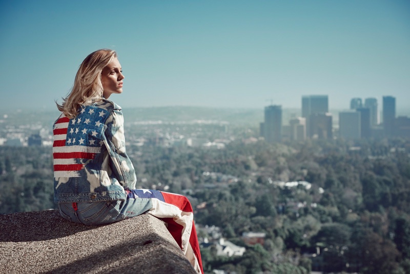 Looking over Los Angeles, Anja models a denim jacket and pants with American flag detail