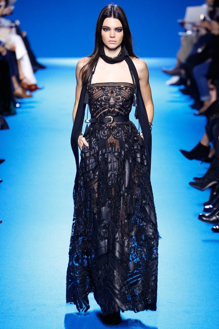 Kendall Jenner walks the runway at Elie Saab's fall-winter 2016 show wearing a strapless gown embellished with leather and beading