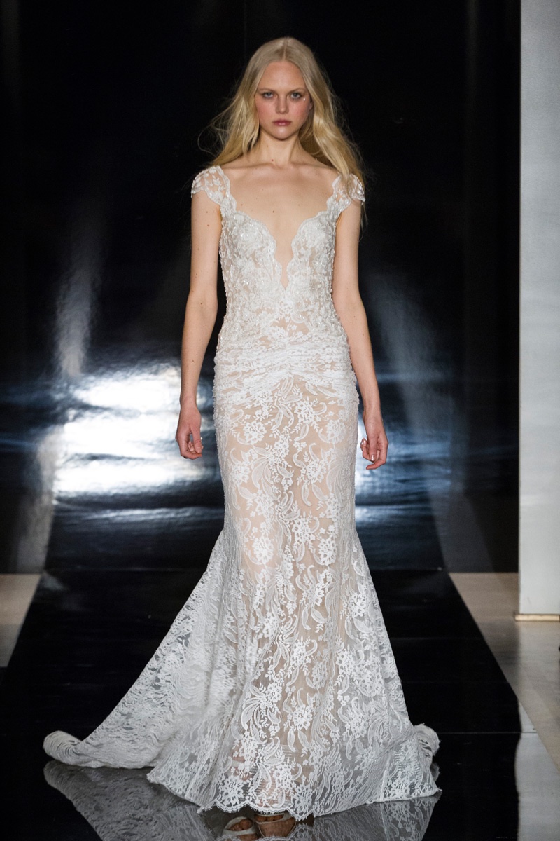 A model walks the runway at Reem Acra's spring 2017 bridal show wearing a hand embroidered Chantilly lace gown with ruched skirt