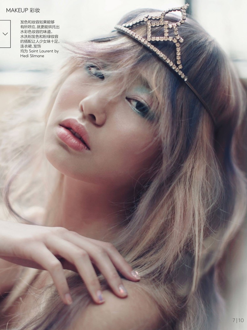 With her hair in undone waves, Estelle Chen poses with a pop of green and pink eyeshadow