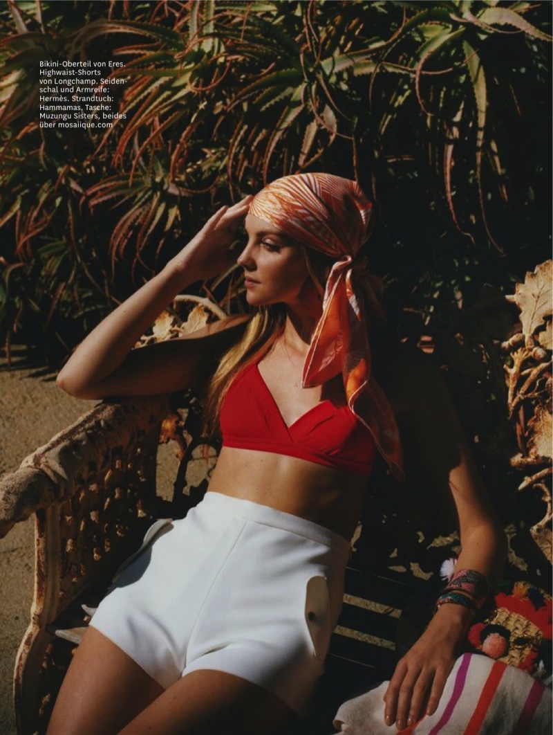 Lounging poolside, Heather Marks wears Eres bikini top, Longchamp high-waisted shorts and Hermes scarf