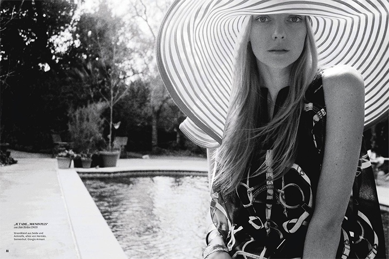 Photographed in black and white, Heather Marks models Hermes printed beach dress with Giorgio Armani hat