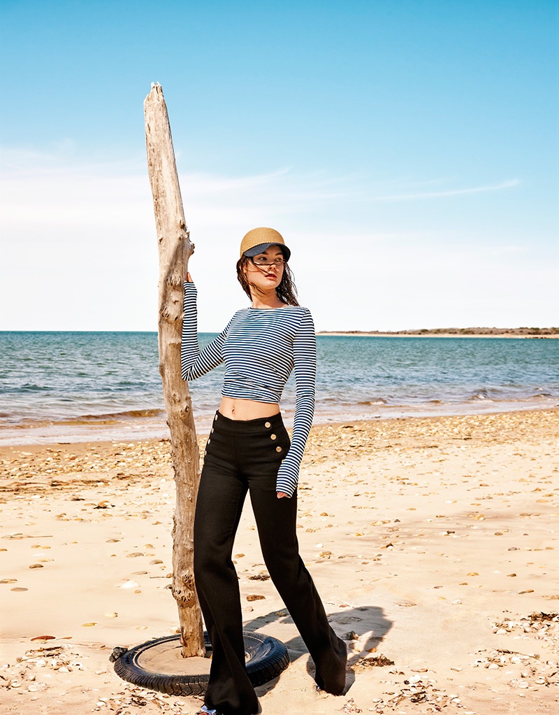 Flaunting her toned stomach, Jac Jagaciak wears striped sweater and black trousers
