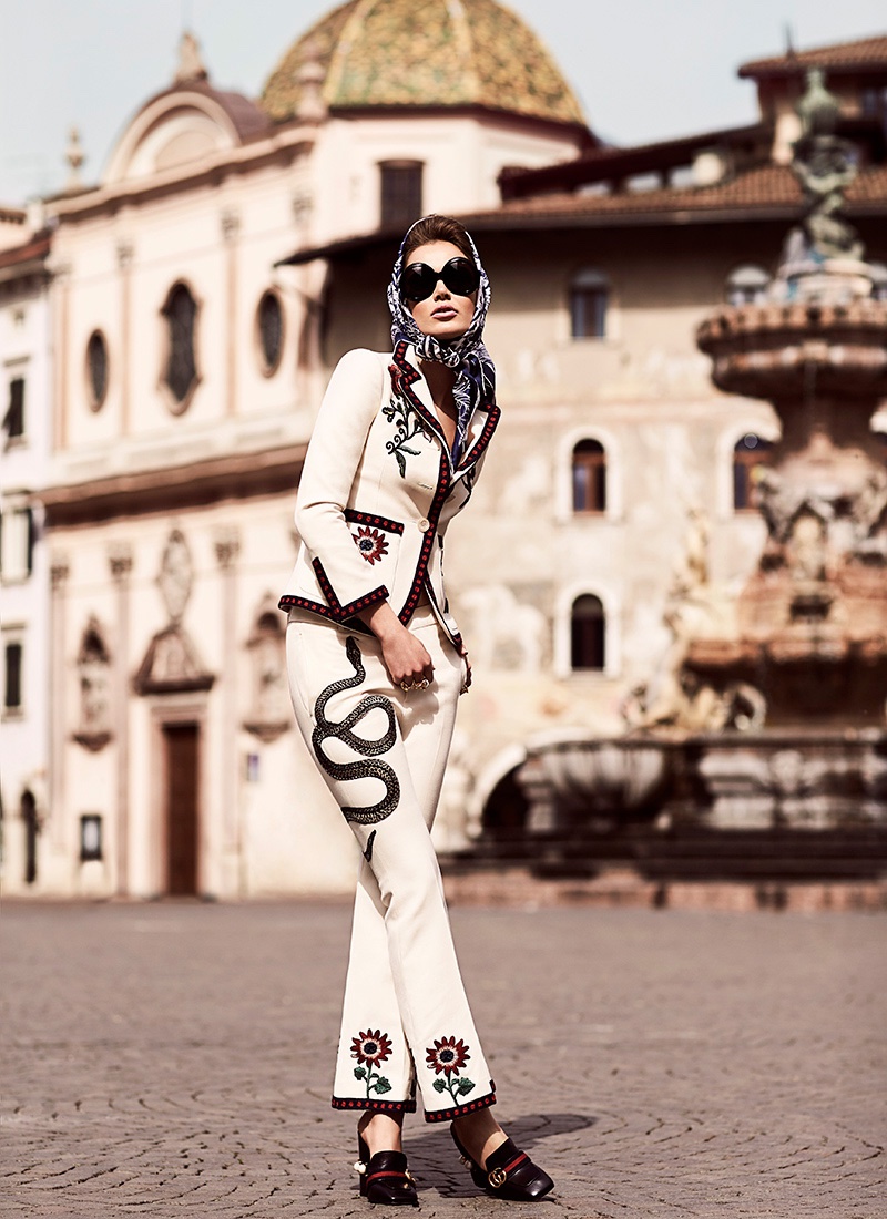 The model wears a Gucci pant suit 