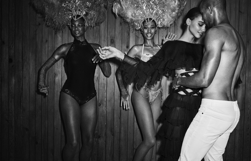 Photographed in black and white, Cora Emmanuel wears Balmain crop top and pants with ruffles