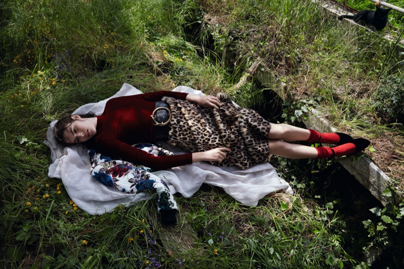 The model poses in a greenhouse wearing bold prints from the fall collections