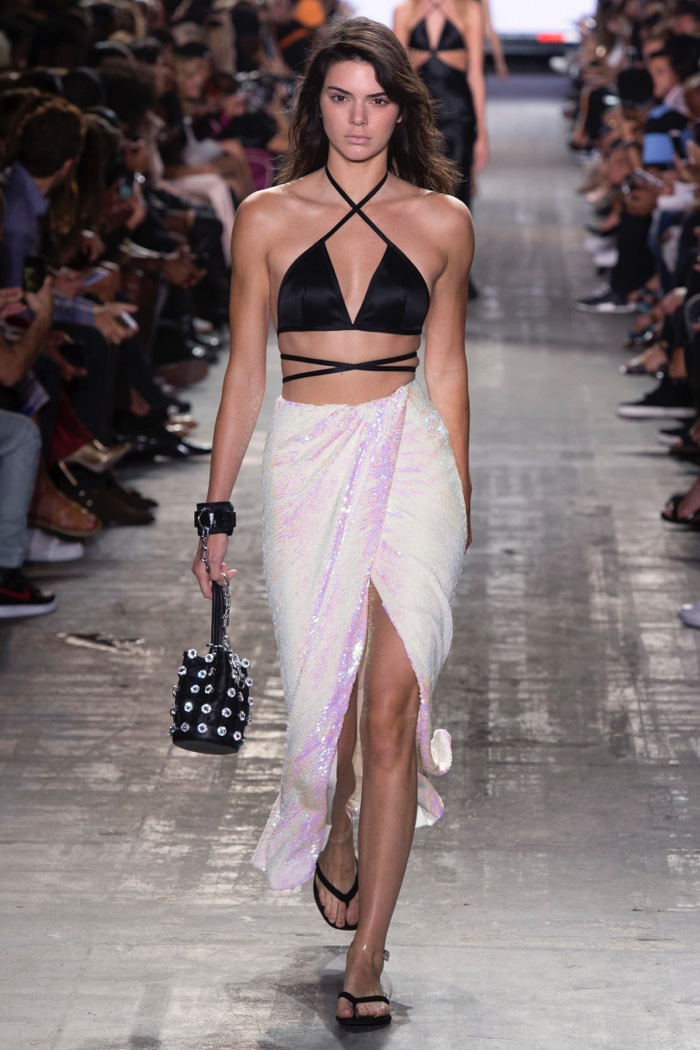 Alexander Wang Spring 2017: Kendall Jenner walks the runway in halterneck bralette and wrapped sequin skirt
