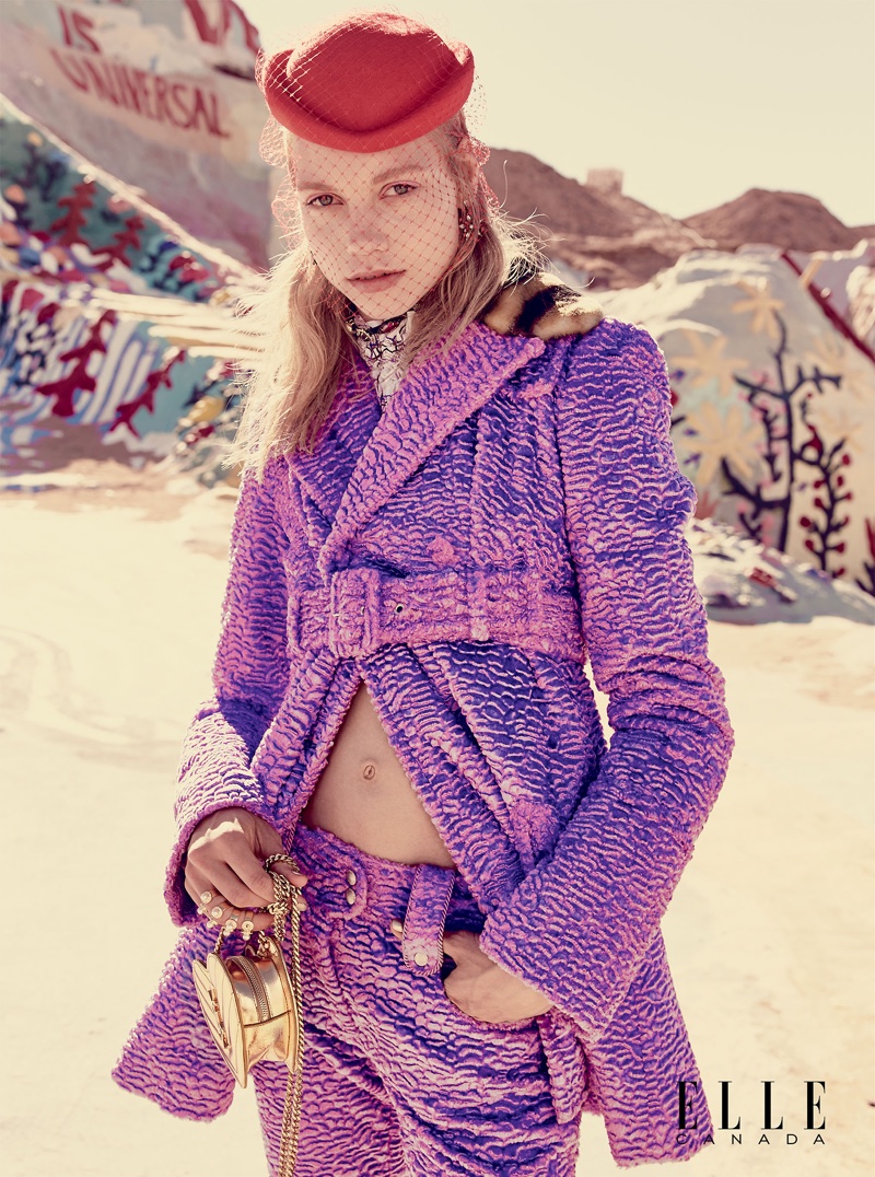 The model wears Kenzo faux fur coat and pants with poplin blouse, leather bag by Saint Laurent