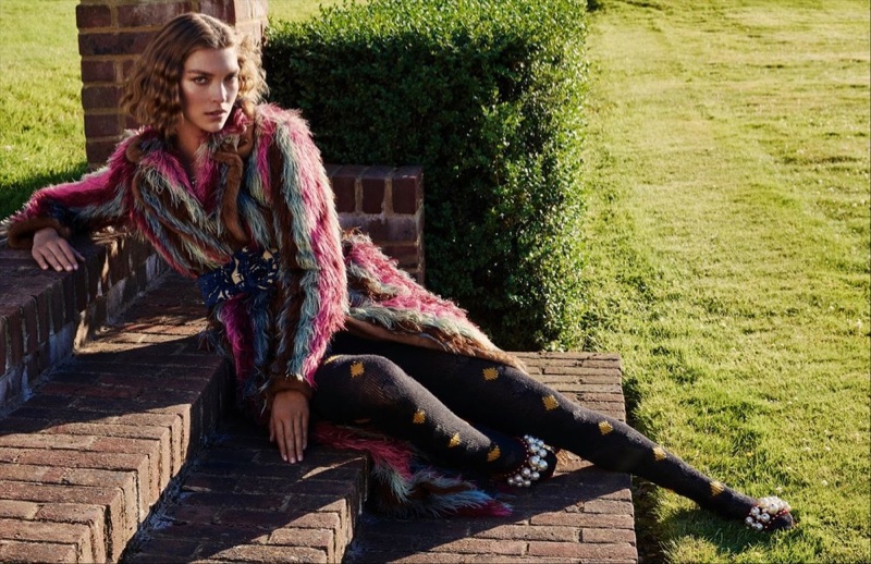 Posing outdoors, Arizona Muse wears Blumarine fur jacket and Prada tights