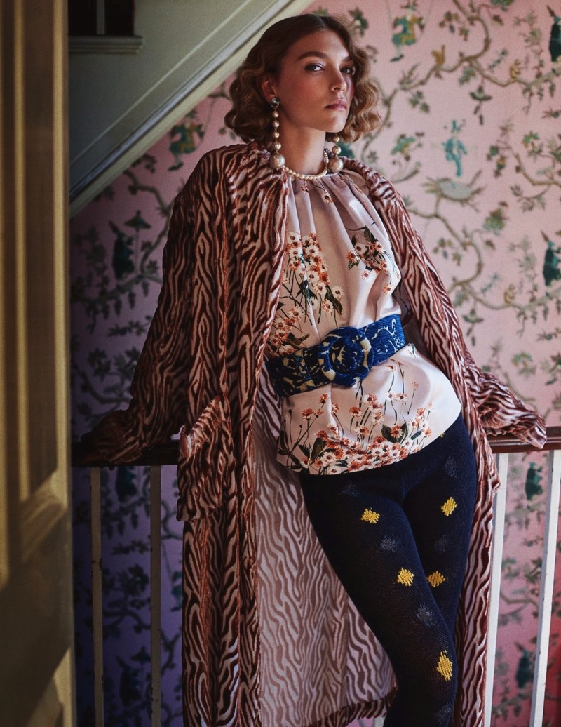 Striking a pose, Arizona Muse wears printed coat over floral print top and Prada leggings