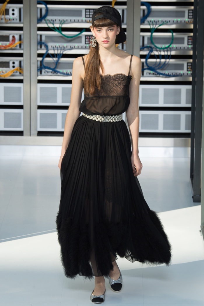 Chanel Spring 2017: Model walks the runway in baseball cap, lace-trimmed top and pleated maxi skirt