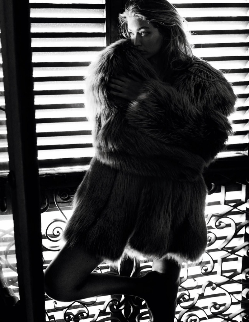 Photographed in black and white, Gigi Hadid models fur coat