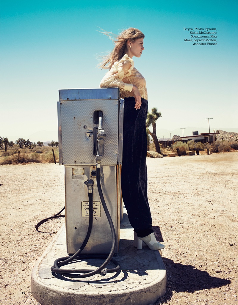 Next to a gas pump, Maryna Linchuk embraces a lace top and pants look