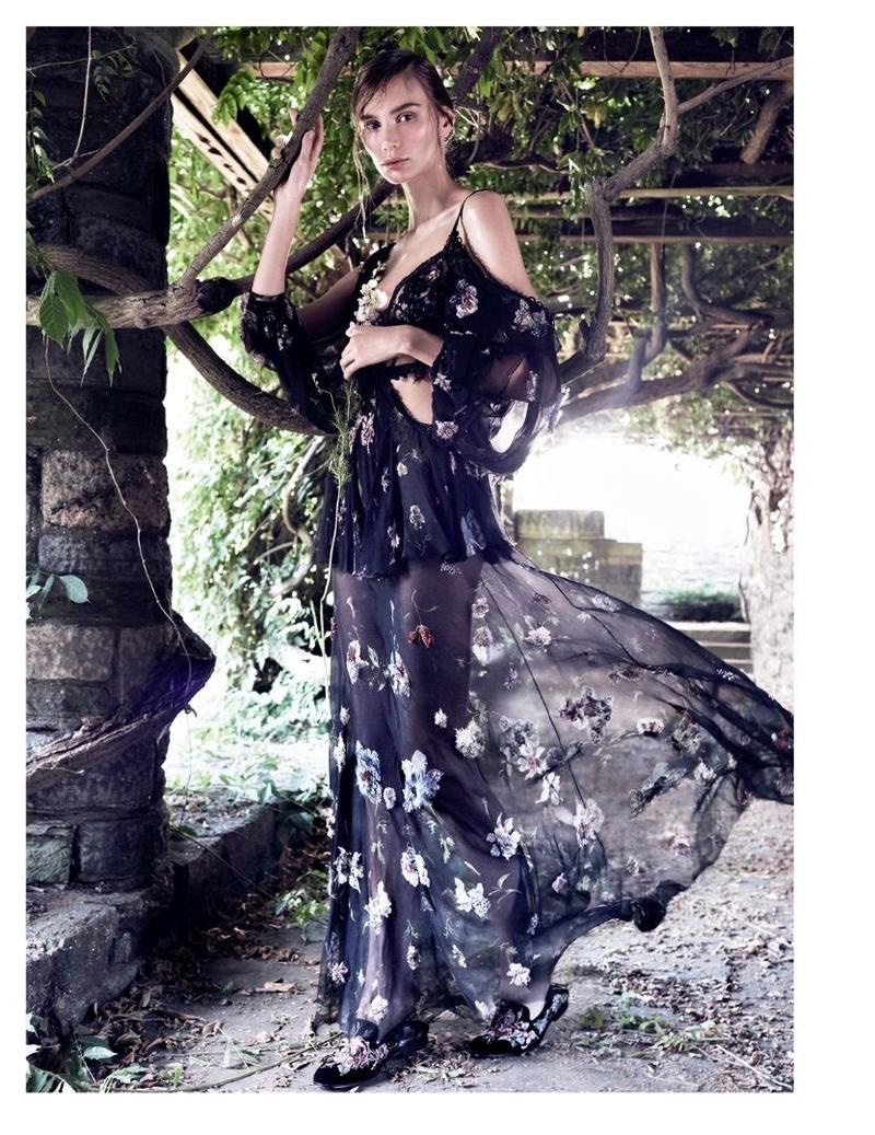 With a windswept look, Natalia Daragan wears Alexander McQueen gown with shoulder cutouts