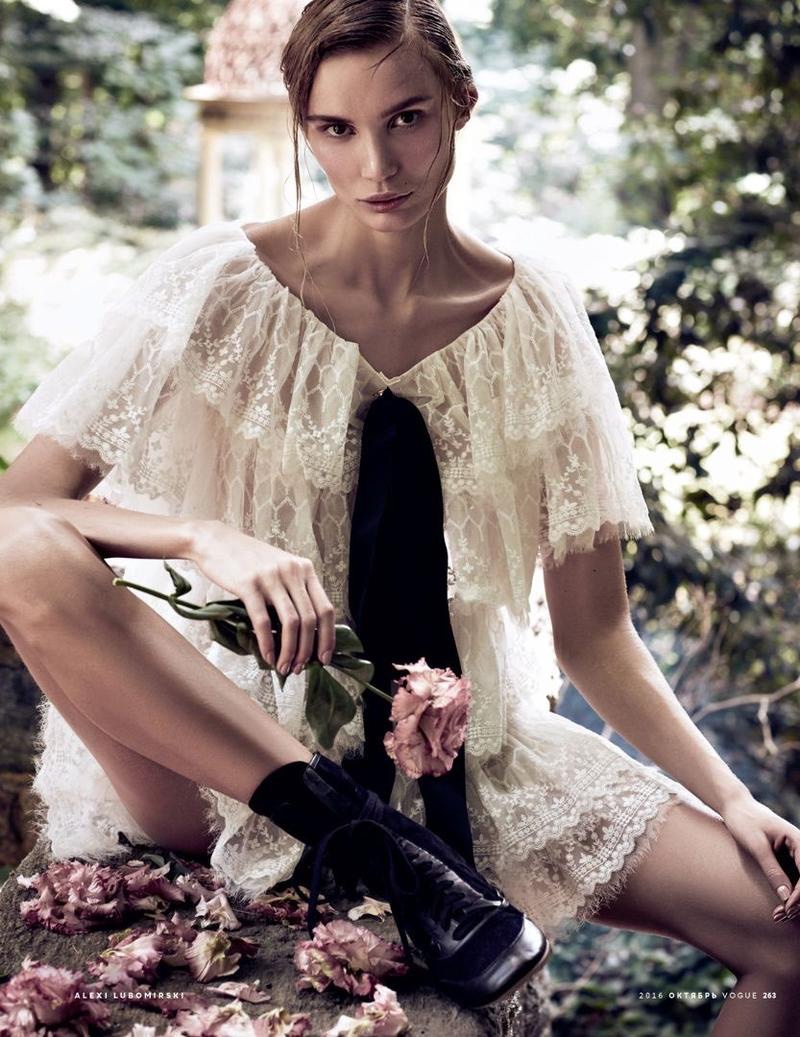 With a flower in hand, Natalia Daragan models Chanel white lace dress