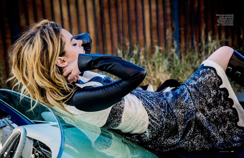 Camille Rowe poses in Louis Vuitton dress and boots