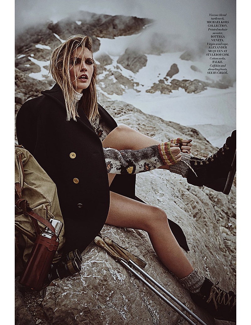 Model Emma Menteath poses in Michael Kors Collection turtleneck, Alexander McQueen wool cape and See by Chloe boots