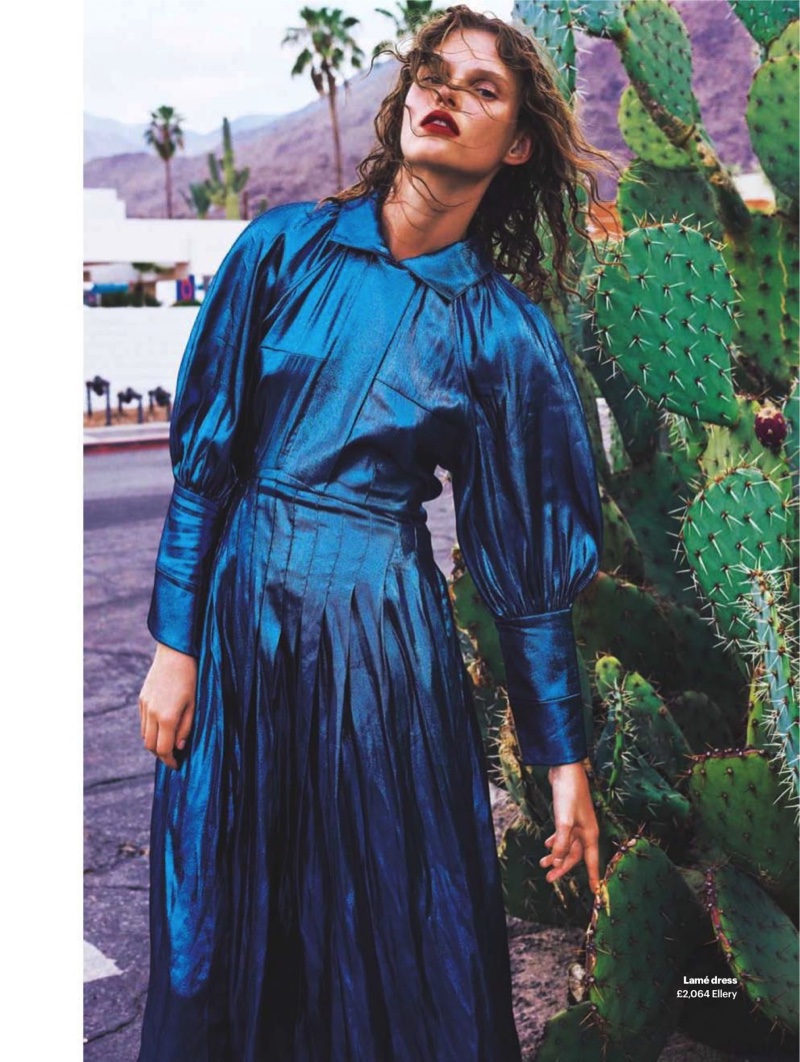 Posing next to cactus, Giedre Dukauskaite models blue lamé dress from Ellery