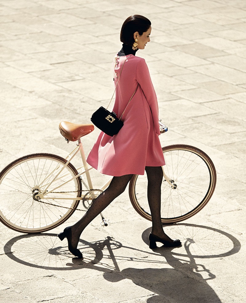 Walking with a bicycle, Hanaa Ben Abdesslem models pink swing dress