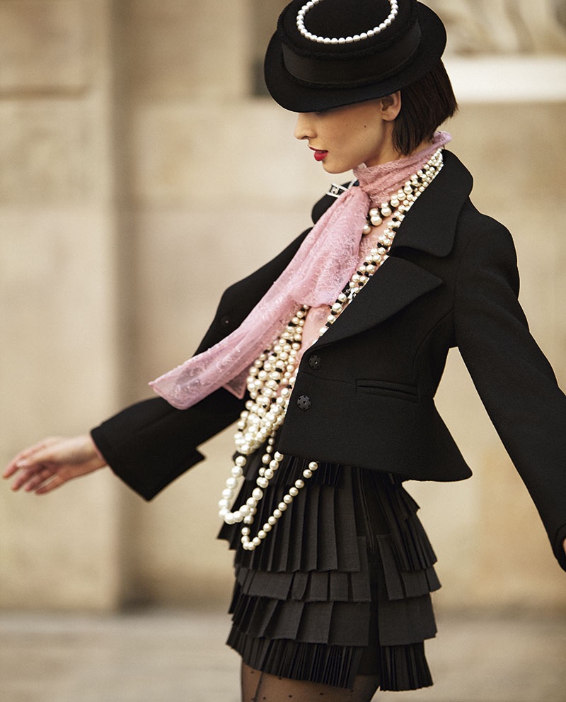 Clad in black, the model hits the streets in a jacket and skirt combination