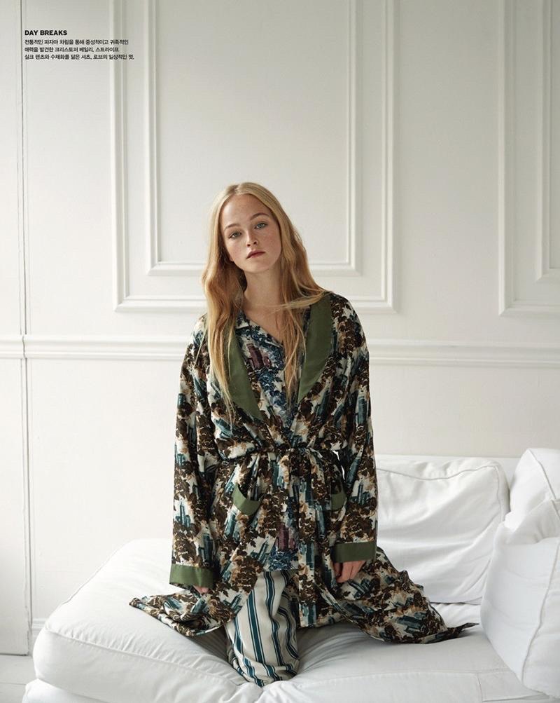 Posing on a bed, Jean Campbell models Burberry pajama inspired separates