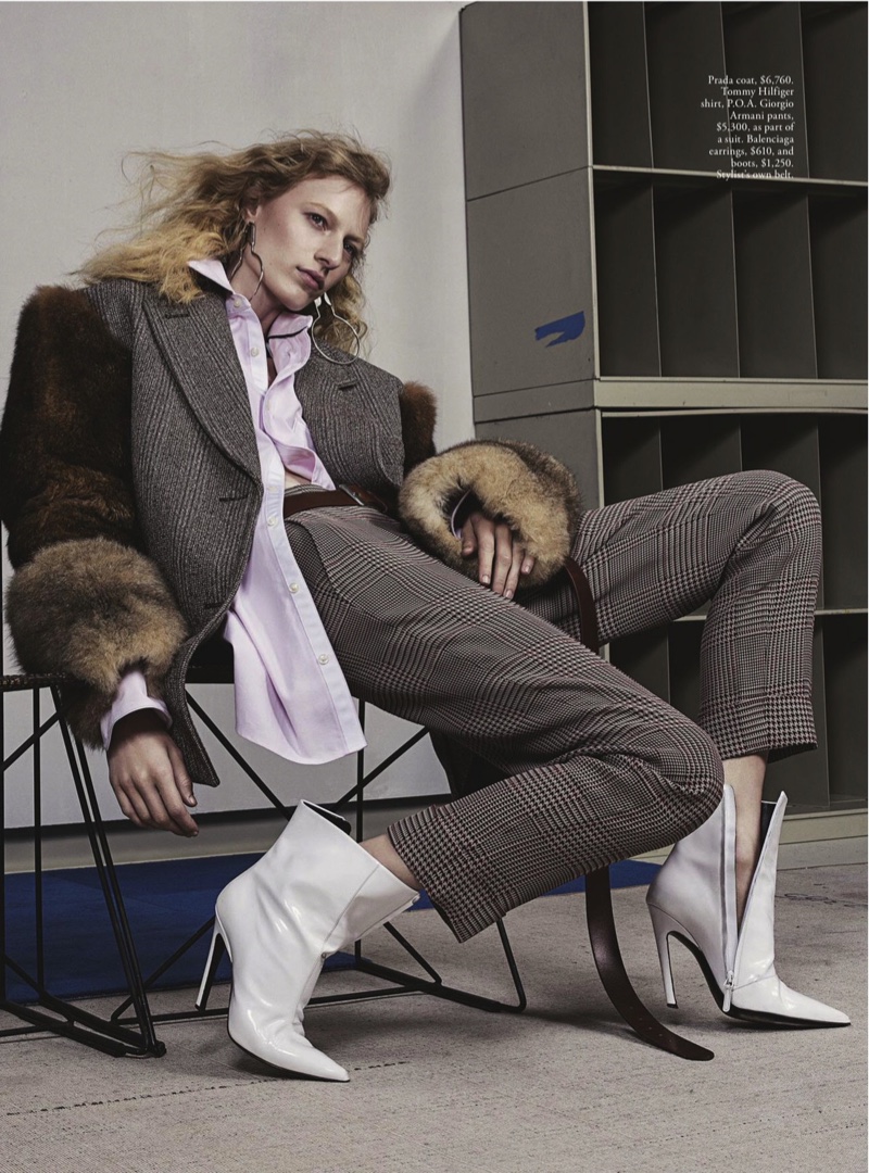 The blonde slouches in Prada coat, Tommy Hilfiger shirt, Giorgio Armani pants and Balenciaga earrings
