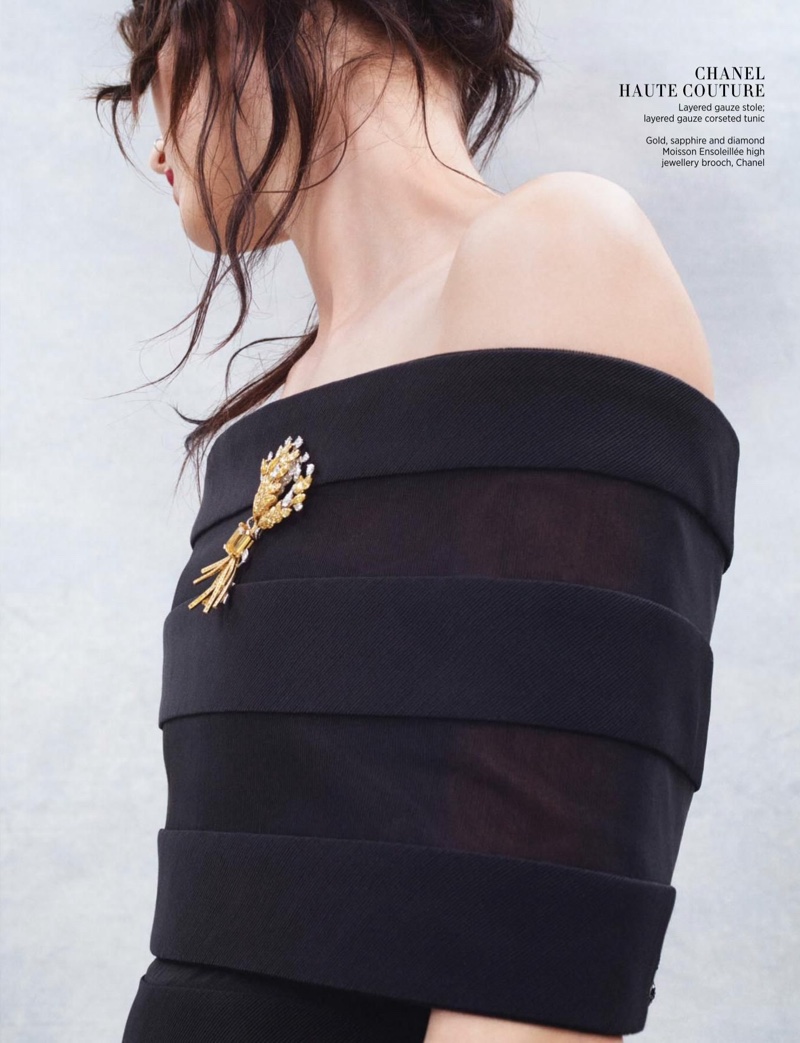 Wearing an off-the-shoulder dress from Chanel Haute Couture, Katlin Aas strikes an elegant pose