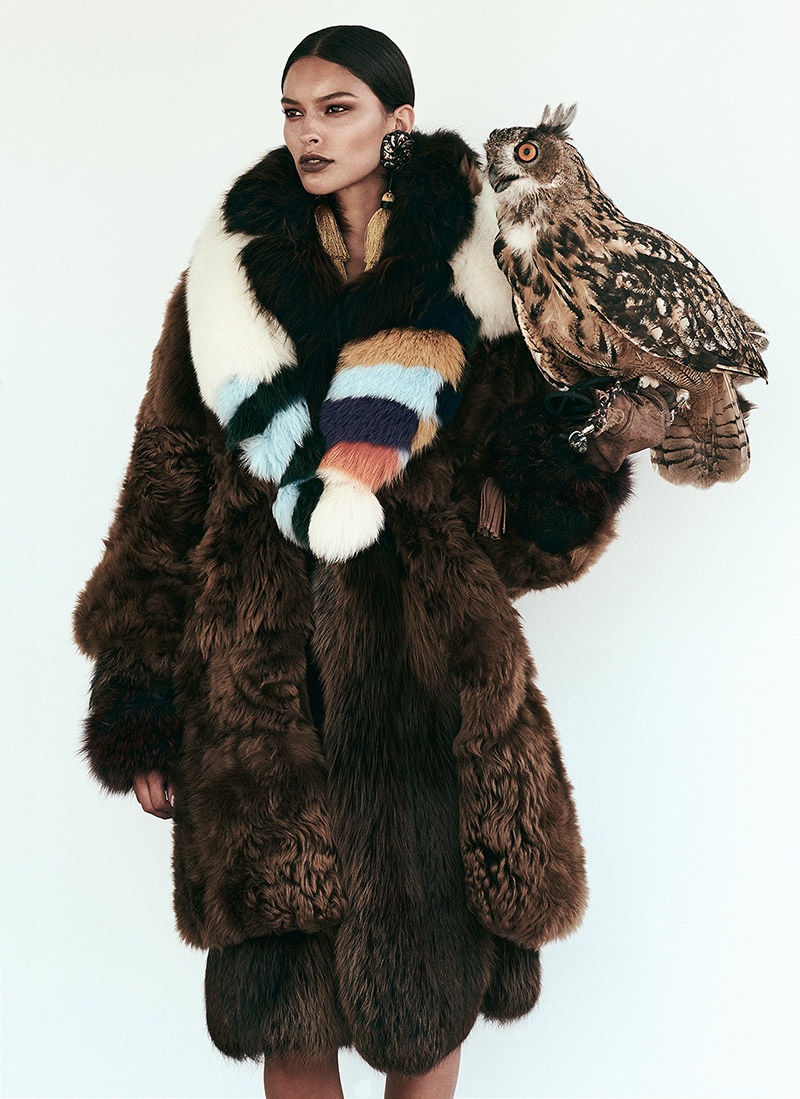 Posing with an owl, the model wears Fendi fur coat and stole with DSquared2 tasseled earrings