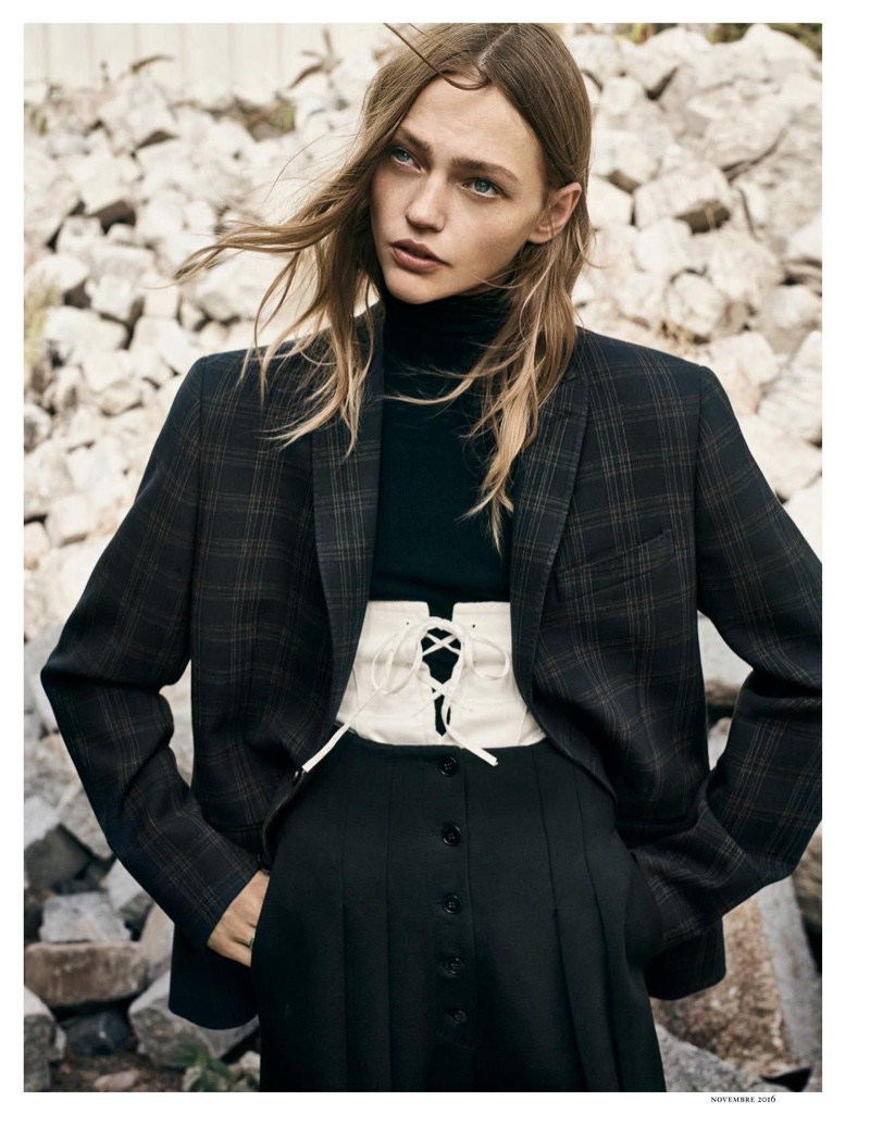 A masculine and feminine look strikes the perfect balance with a plaid jacket and corset detail