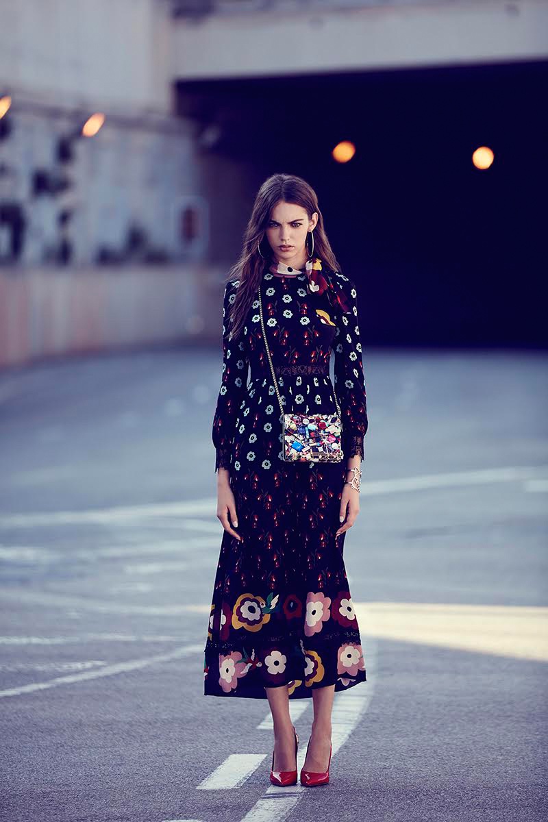 Looking ladylike, the model wears RED Valentino dress, Mango earrings, Jimmy Choo bag, Chanel bracelet and Louis Vuitton heels