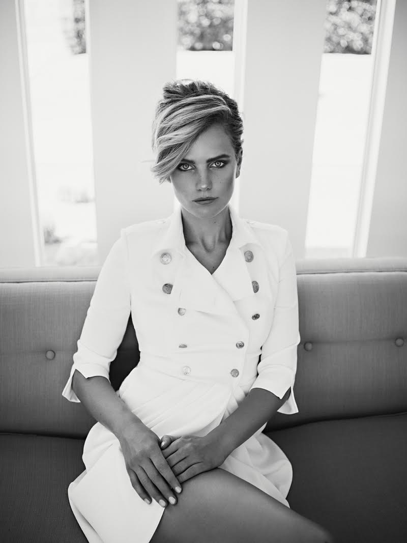 Photographed in black and white, the model poses in Elisabetta Franchi dress
