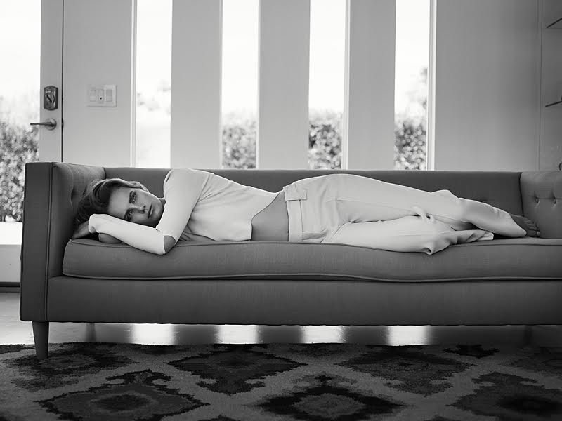 The model lounges in Asilio top and Dorothee Schumacher pants