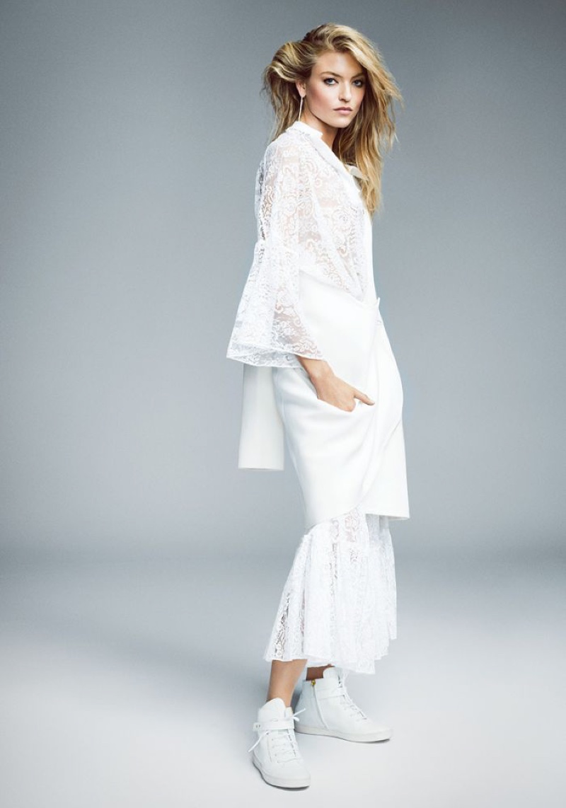 Martha Hunt models Valentino lace top and pants with Dior coat and Giuseppe Zanotti boots