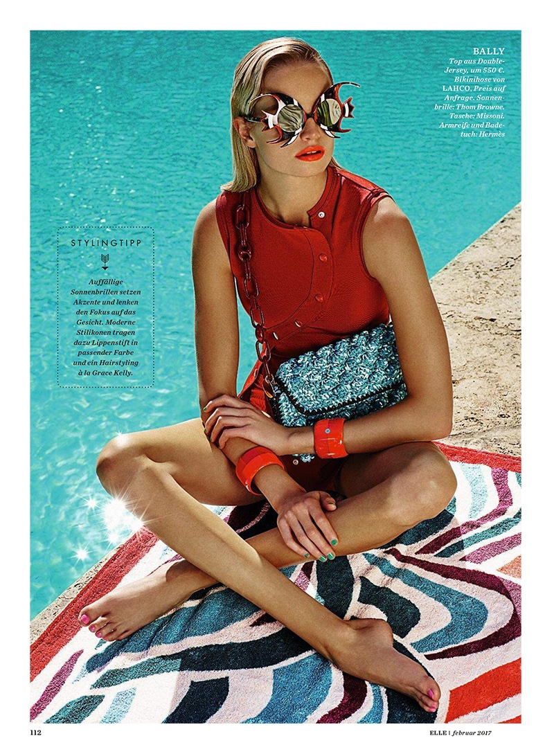 The model poses in Bally top, LAHCO bikini bottoms, Thom Browne sunglasses and Missoni bag