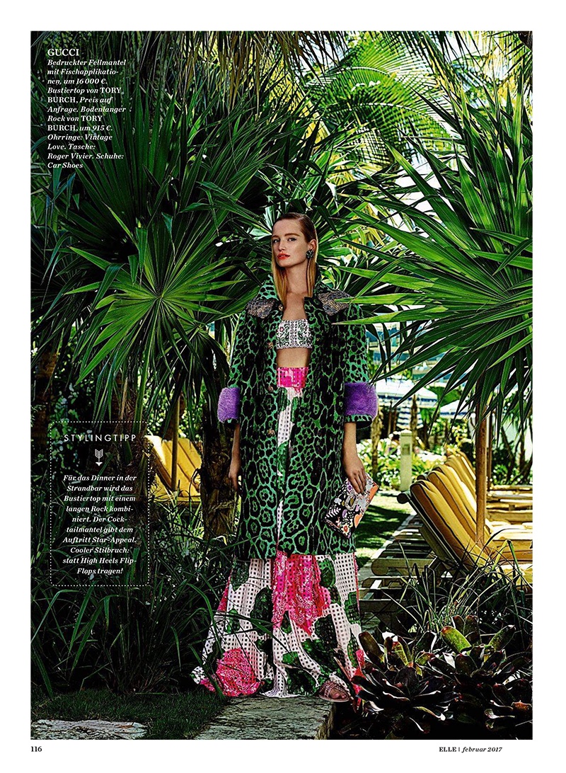 The model wears Gucci fur coat, Tory Burch bustier top and maxi skirt