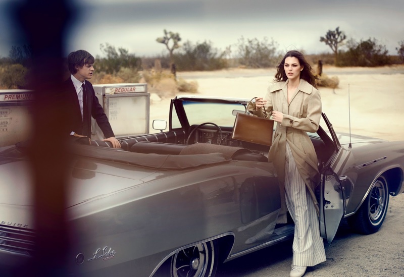 The model covers up in a Jacquemus coat and pants with Celine bag