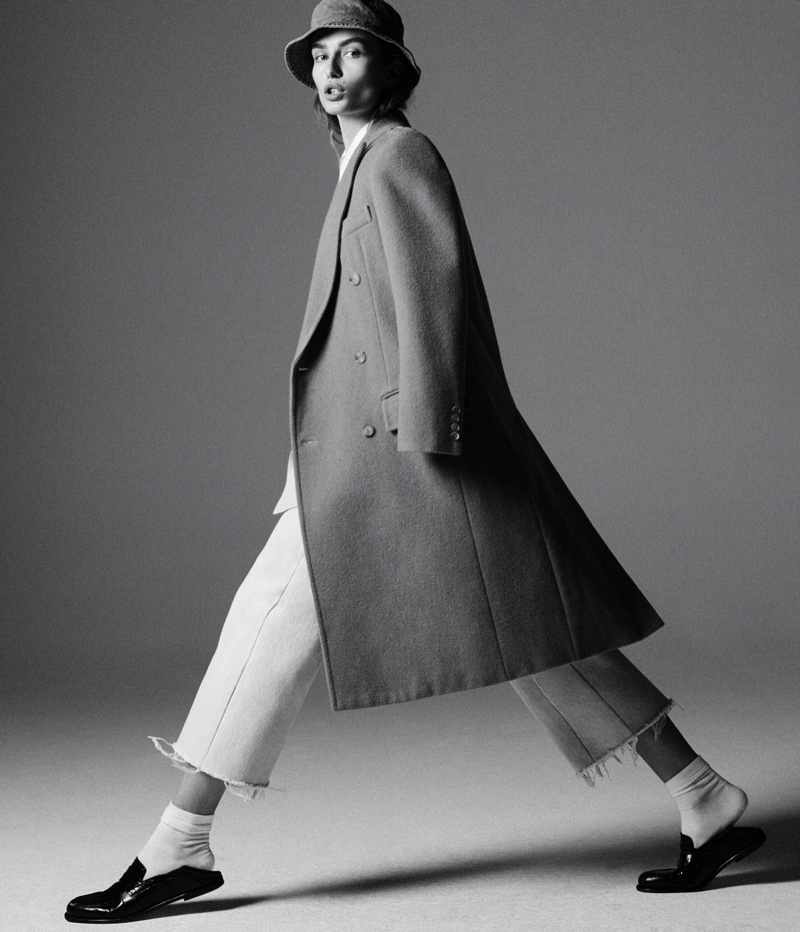 Andreea Diaconu poses in Ralph Lauren Collection coat and jacket with Re/Done Levi’s jeans and Loewe loafers