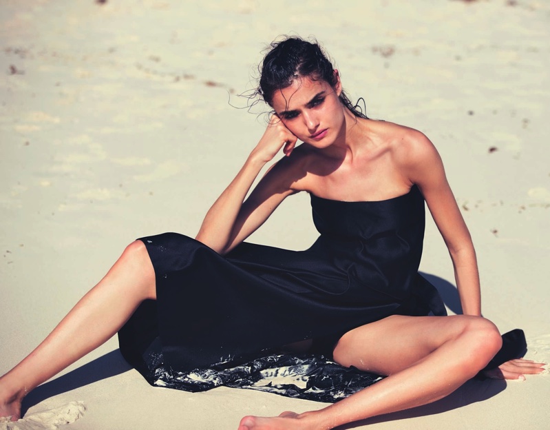 Clad in black, Blanca Padilla models Miu Miu bandeau top, skirt and shorts